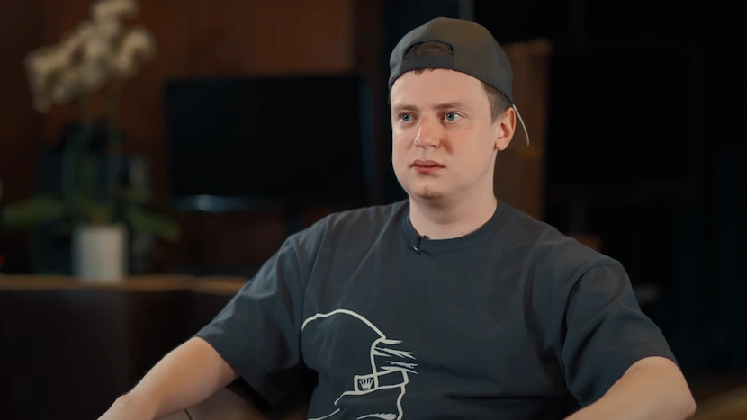 Mellstroy sitting at a table in casual black shirt